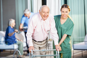 Elder man with walker being aided by orderly